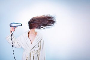 Woman blow drying hair