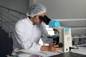 Scientist looking at hair follicles